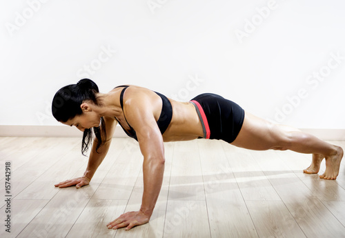 Fit woman warming up and doing some push ups