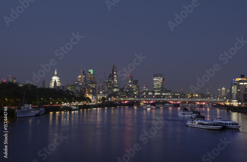 skyscrapers in london city with st paul s cathedral at night seen over thames river