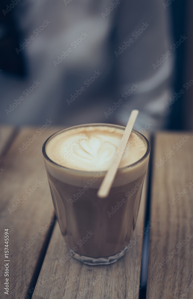 Latte art in glass. Coffee espresso on wooden table Latte art in glass. Coffee espresso on wooden table