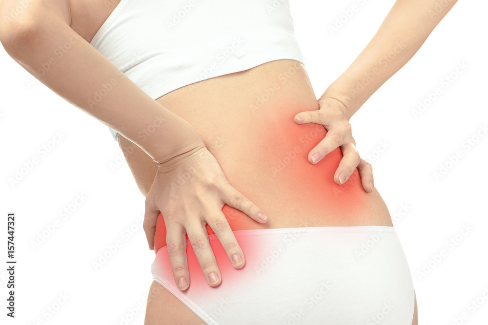 Young woman suffering from back pain on white background, closeup