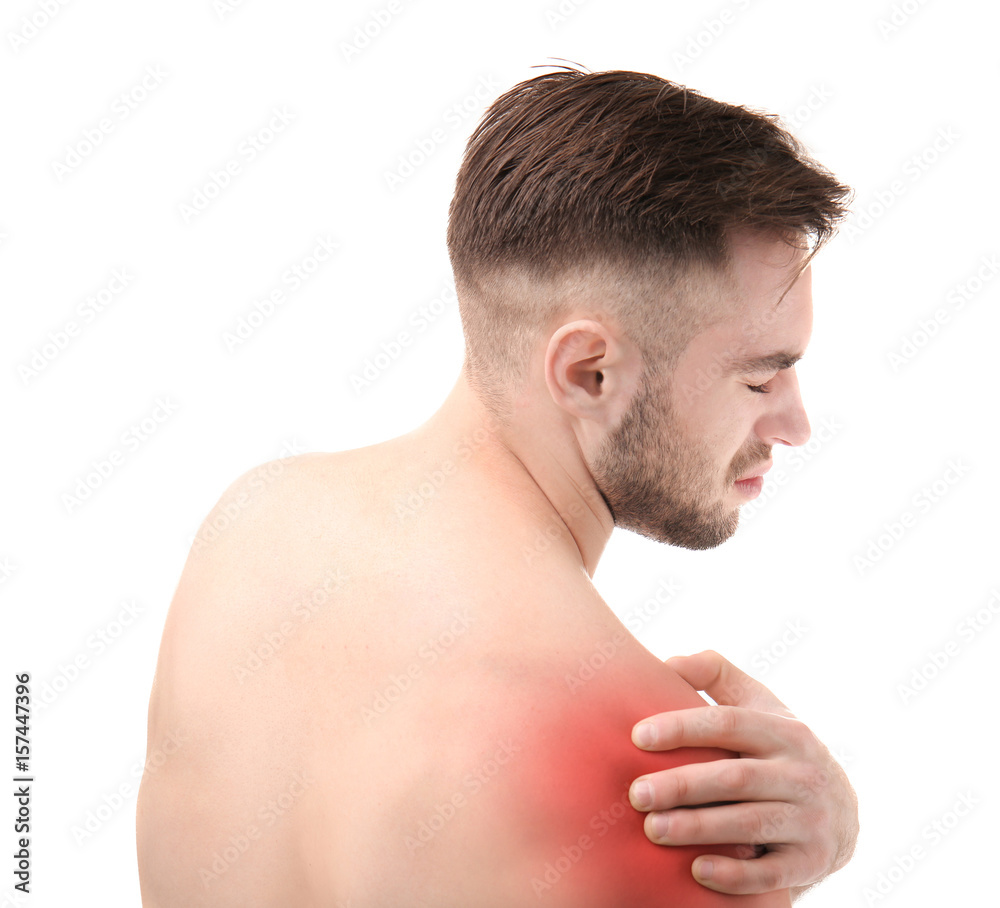 Fototapeta premium Young man suffering from pain in shoulder on white background