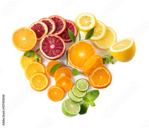 Slices of delicious citrus fruits on white background