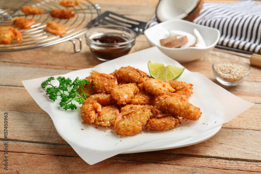 Plate with delicious coconut shrimps on table Plate with delicious coconut shrimps on table