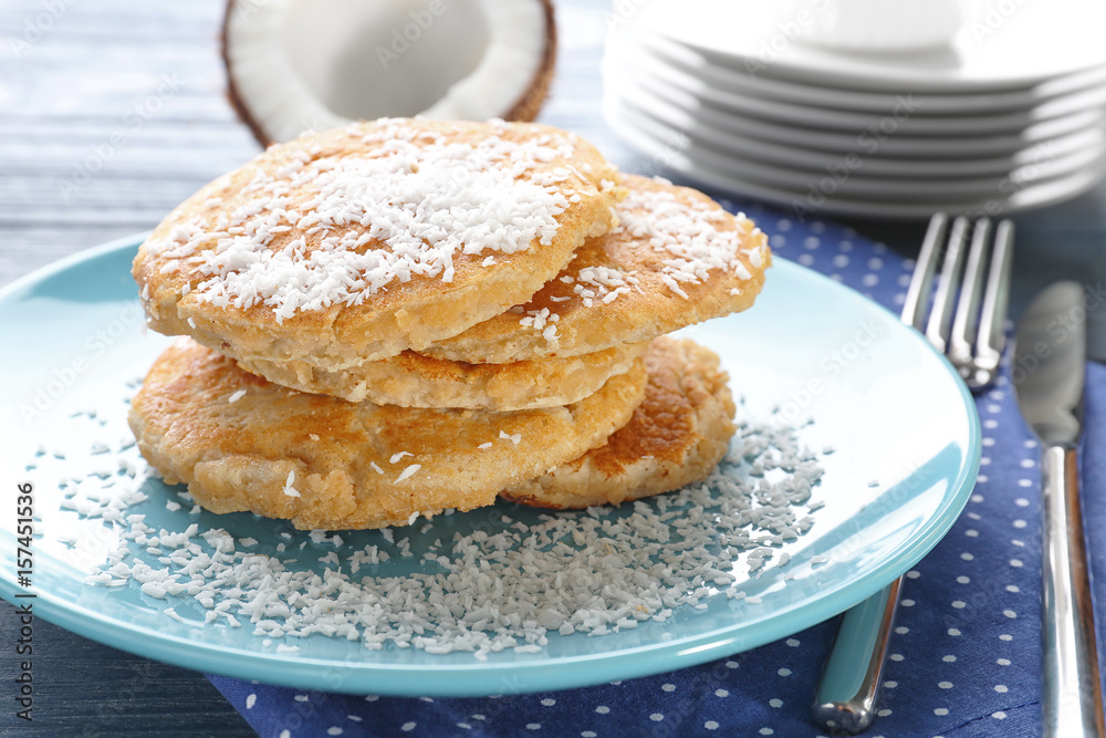 Plate with tasty homemade coconut pancakes on table Plate with tasty homemade coconut pancakes on table