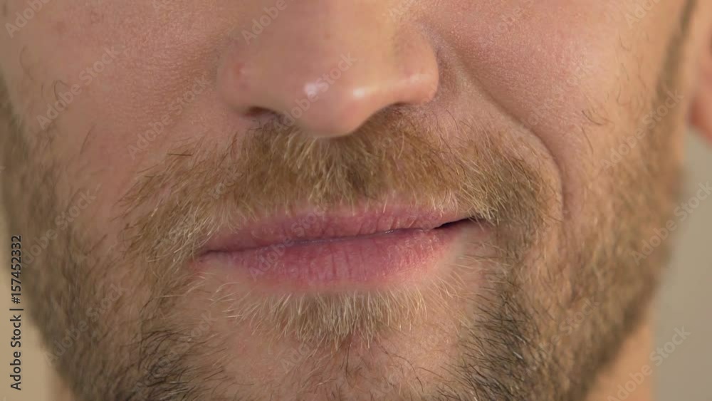 Close up of man's face smirking into camera, arrogant male, body language Close up of man's face smirking into camera, arrogant male, body language