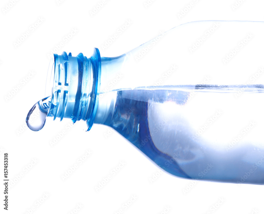 Water pouring from plastic bottle on white background Water pouring from plastic bottle on white background