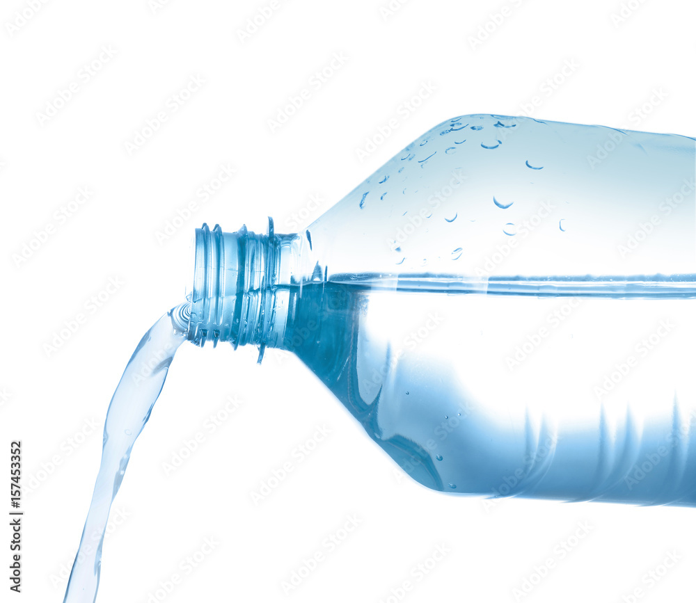Water pouring from plastic bottle on white background Water pouring from plastic bottle on white background