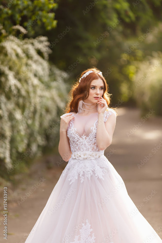 Beautiful redhead Bride. Portrait outdoor in sunset light. Pretty young caucasian redhead girl Beautiful redhead Bride. Portrait outdoor in sunset light. Pretty young caucasian redhead girl