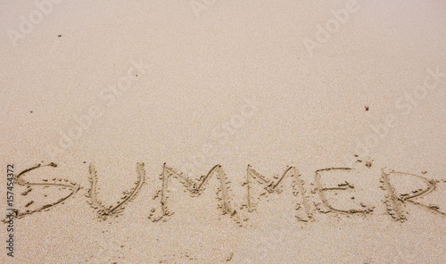 The word "summer" on the sand of the beach © E.O.