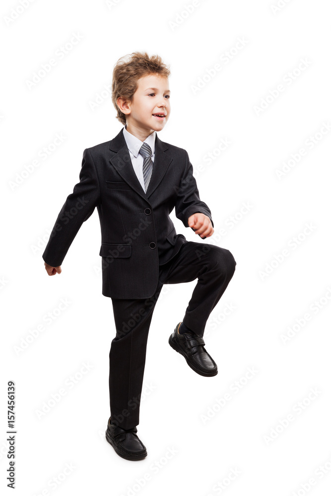 Smiling businessman child boy walking for next achievement step Smiling businessman child boy walking for next achievement step