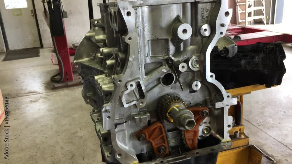 Newer engine being lowered from chains in servicing center for better mechanical access. Newer engine being lowered from chains in servicing center for better mechanical access.