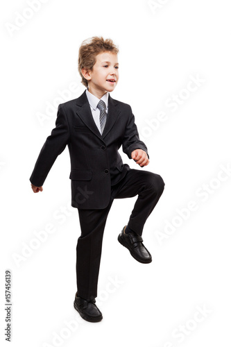 Smiling businessman child boy walking for next achievement step