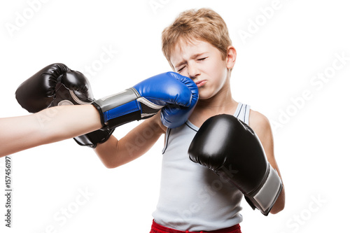 Handsome boxer child boy training boxing sport got punched