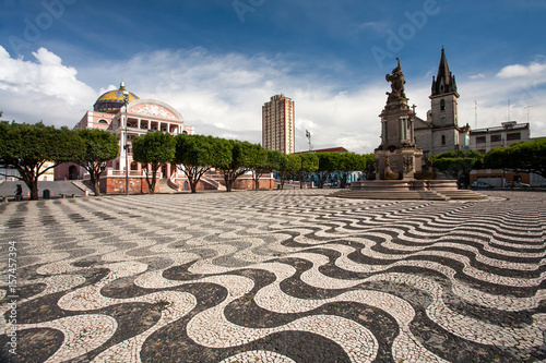 Manaus city sidewalk with Amazon theatre and church photo