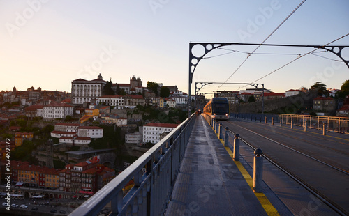 Ponte Dom Luís I during sunset with yellow metro trams - Porto, Portugal