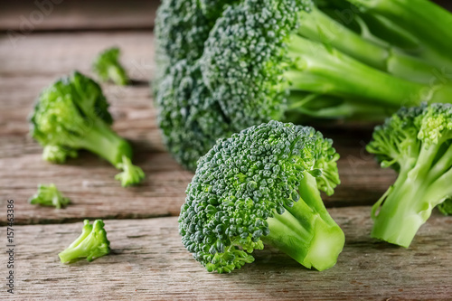 Pieces of broccoli, rustic style, old wooden background
