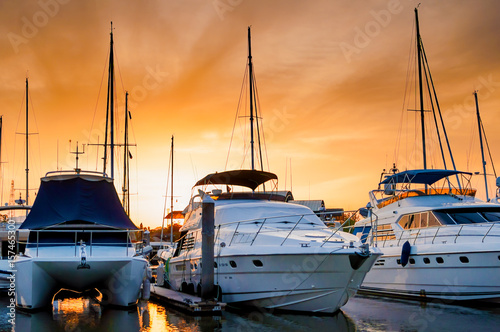 Yacht and boats docking at the marina in the evening photo