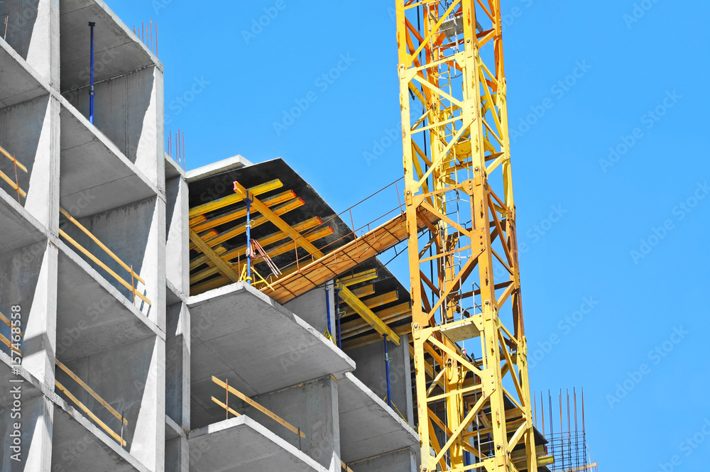 Crane and highrise construction site Crane and highrise construction site