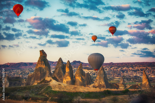 Hot air balloons flying over the valley at Cappadocia.