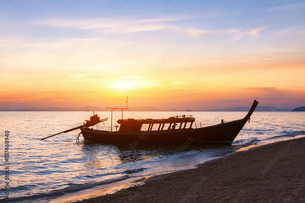 Silhouette of a traditional long-tail boat, beach, sunset Silhouette of a traditional long-tail boat, beach, sunset