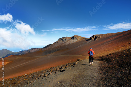Tourist hiking in Haleakala volcano crater on the Sliding Sands trail.