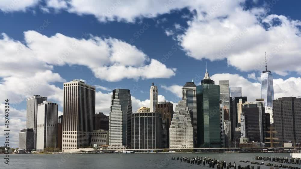 Time lapse! Fluffy clouds over financial district, Manhattan Island, New York City. Seen from Brooklyn