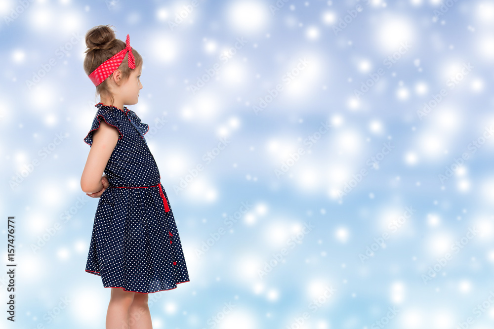 Fototapeta premium Little girl in blue polka dot dress.