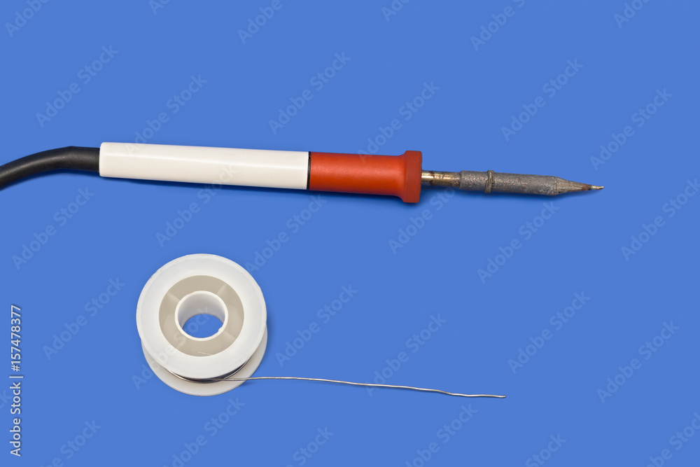 Naklejka premium Soldering iron weldingon blue background