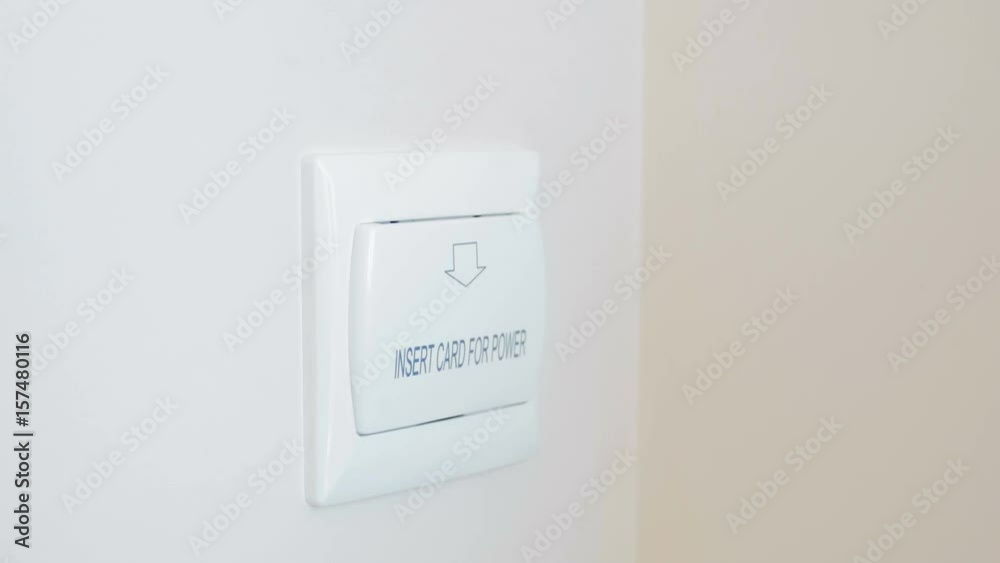 Closeup video of woman taking out electronic key from holder on wall at hotel room Closeup video of woman taking out electronic key from holder on wall at hotel room