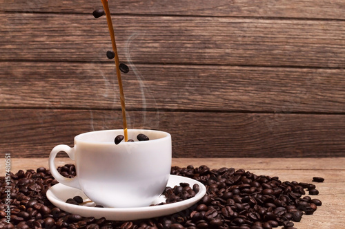 pouring coffee and rosted coffee beans photo