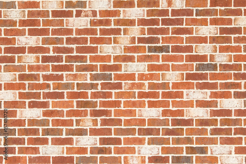 Brick wall with orange, brown and white bricks.