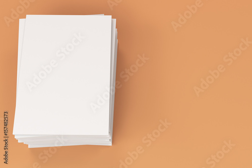 Stack of blank white closed brochure mock-up on orange background