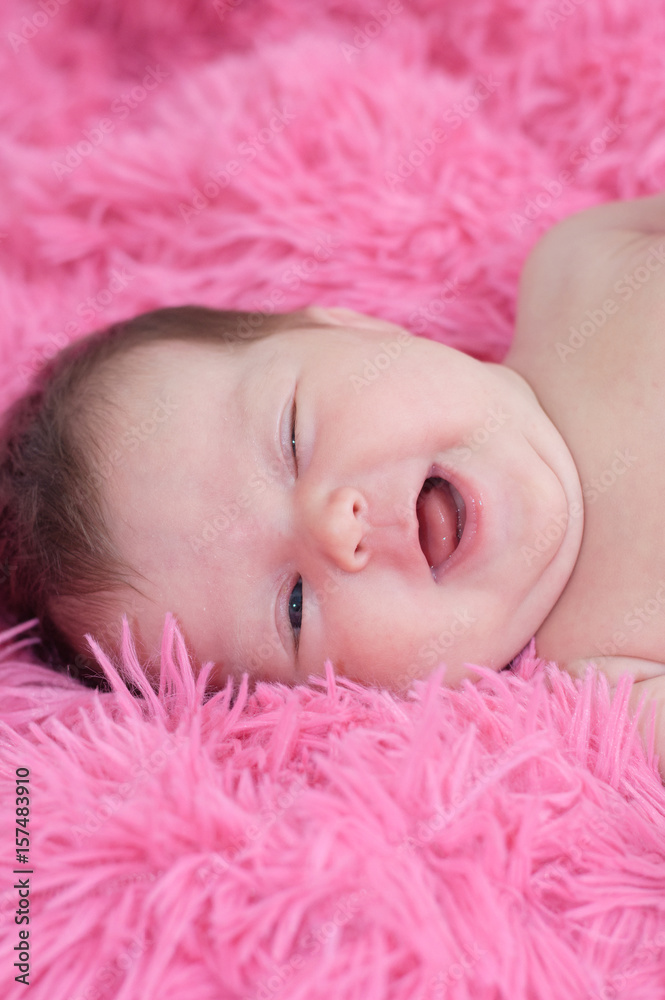 Happy smiling baby portrait, newborn baby girl lying on pink background looking at camera. Happy smiling baby portrait, newborn baby girl lying on pink background looking at camera.