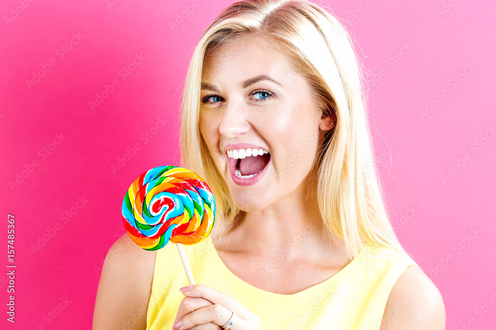 Young woman holding a lollipop