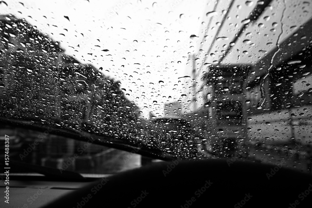 Windshield wipers from inside of car, season rain.