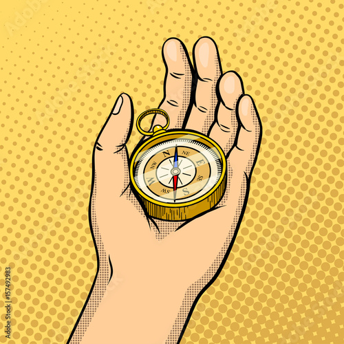Compass in hand pop art vector illustration