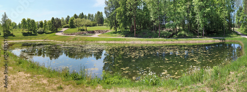 Panorama of a small rural pond with still water