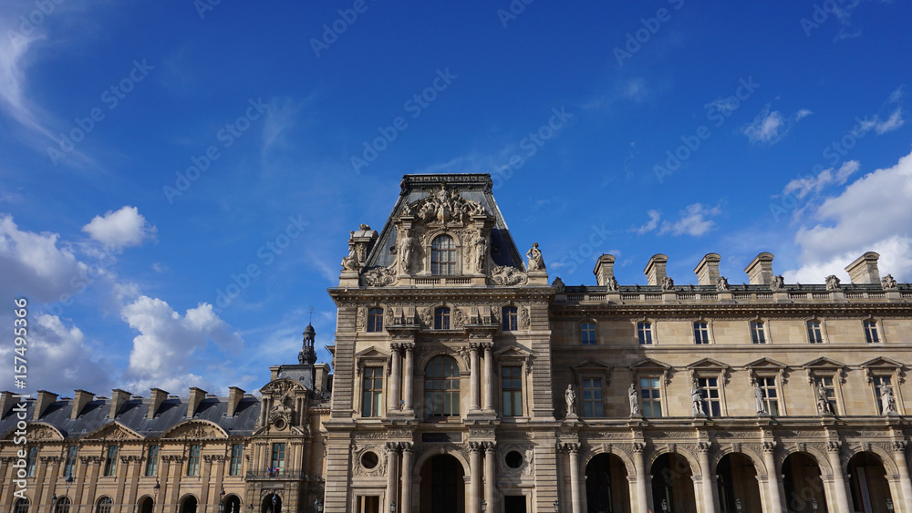 Photo of iconic Louvre Palace on a cloudy spring morning, Paris, France