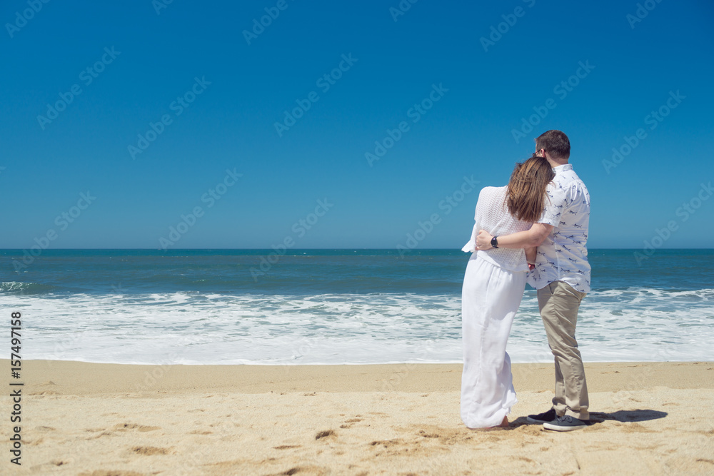 Young romantic couple hugging on the beach Young romantic couple hugging on the beach
