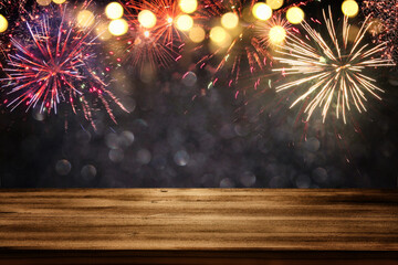 Empty wooden table in front of fireworks background