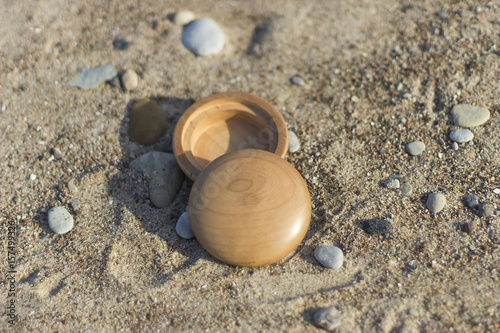 Wooden vessel in the sand between the rocks