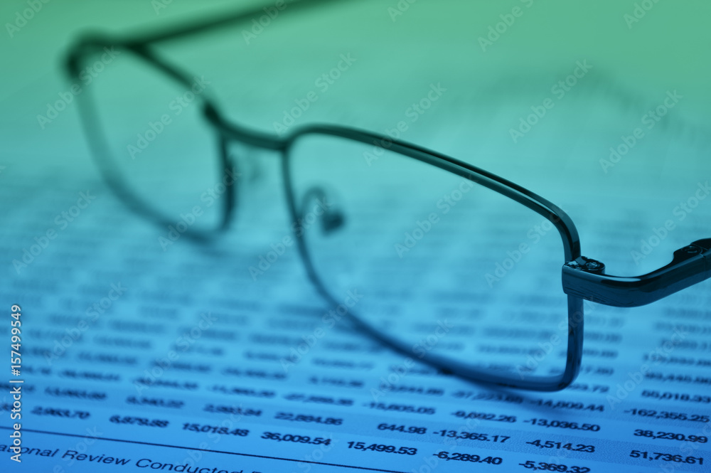 Glasses on financial graph, Business vision concept Glasses on financial graph, Business vision concept