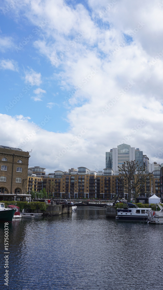 Obraz premium Photo of Saint Katharine's docks near Tower Bridge on a cloudy spring morning, London, United Kingdom