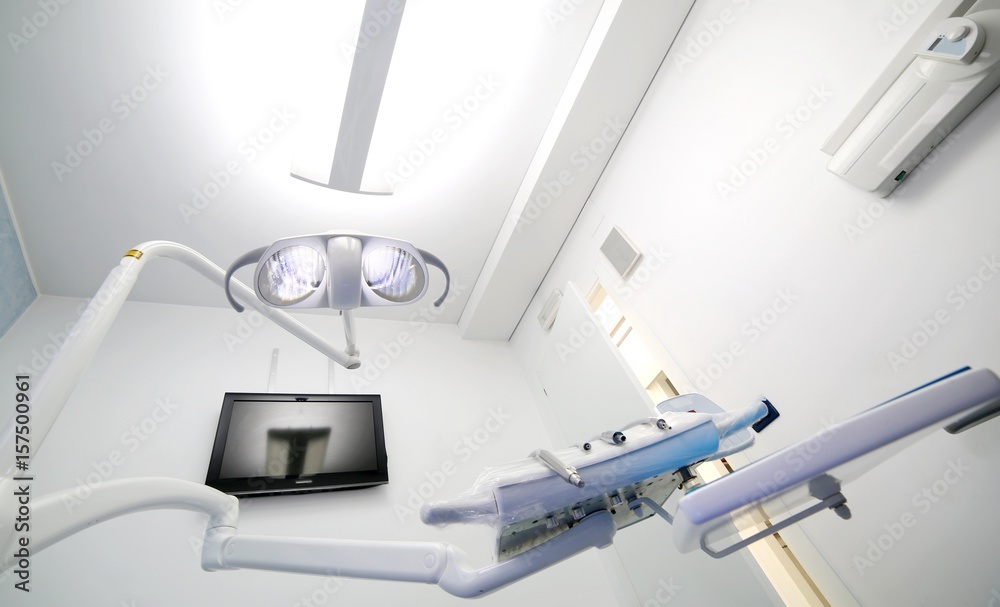 Inside a dental clinic with large halogen light Inside a dental clinic with large halogen light