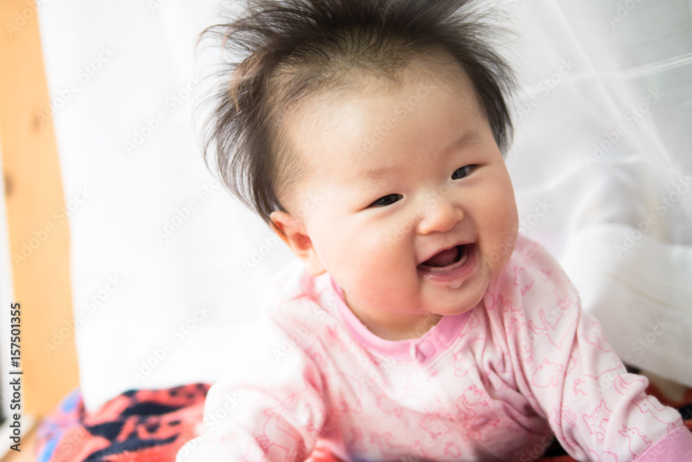 Baby playing at the window side curtain race / Six months after birth Baby playing at the window side curtain race / Six months after birth