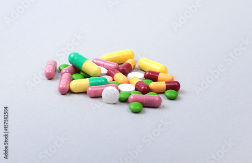 Assorted pills isolated on white background. Selective focus.