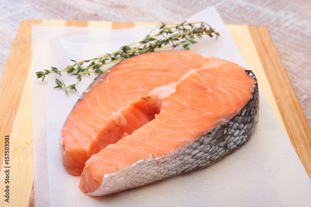 fresh raw salmon with spices on wooden cutting board. ready for cookin fresh raw salmon with spices on wooden cutting board. ready for cookin
