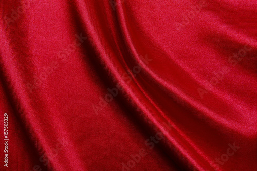 Smooth elegant red silk or satin luxury cloth texture as abstract background. Luxurious background design