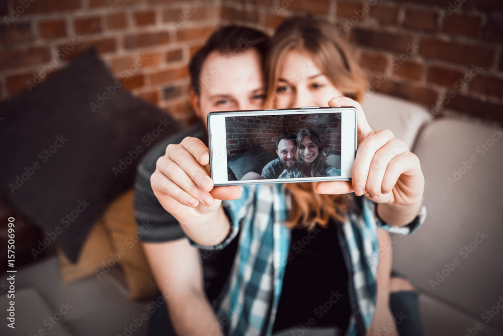 Couple making selfie. In home.