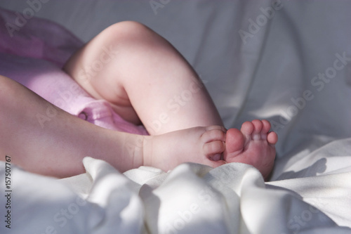 Legs of a young child on a white background close-up